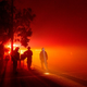 Firefighters monitor flames as they approach a residence in the valley area of Vacaville, northern California during the LNU Lightning Complex fire on August 19, 2020.